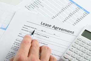 A person filling out a lease agreement